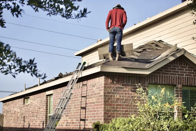 Professional roofer working on a residential roof in East Chautauqua